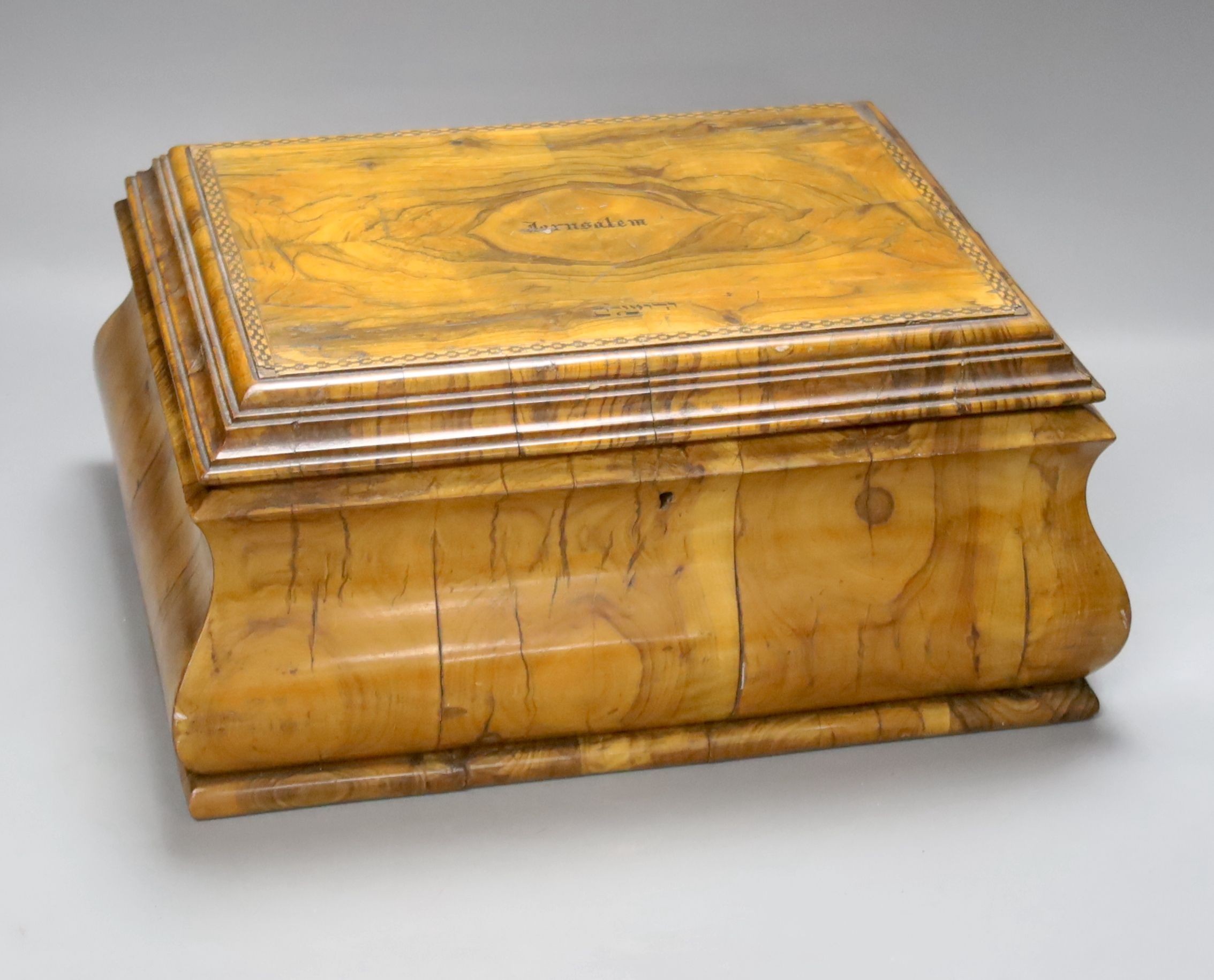 A Jerusalem olivewood casket, bombe shape with inset photograph, width 34cm